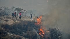 FILE: Residents try to extinguish the blazes in Omodos village, Cyprus, during a massive wildfire on the southern side of the island, 24 July 2025