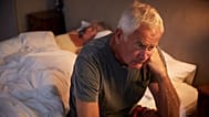 An older man cannot fall asleep.