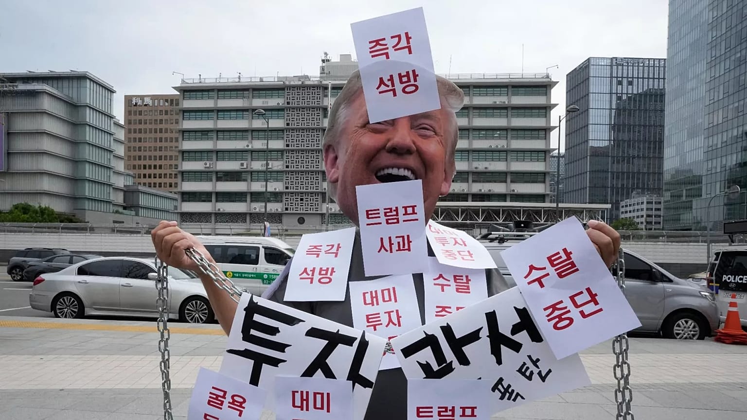 A demonstrator wearing a Donald Trump mask protests against the detention of South Korean workers during an immigration raid in Georgia, 9 September, 2025