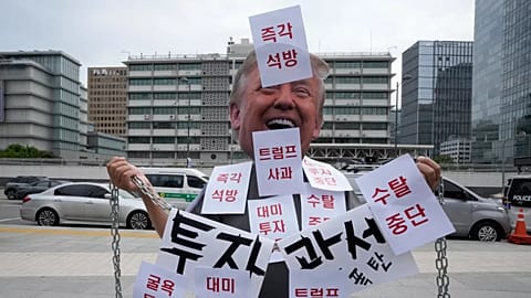 A demonstrator wearing a Donald Trump mask protests against the detention of South Korean workers during an immigration raid in Georgia, 9 September, 2025
