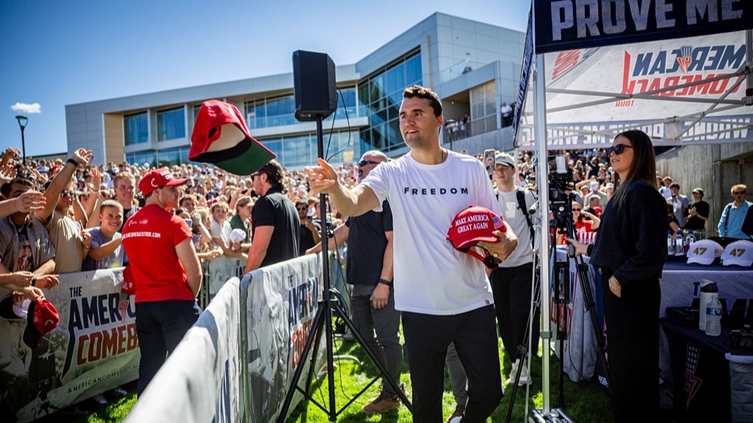 Charlie Kirk hands out hats before speaking at Utah Valley University in Orem, Utah, Wednesday, Sept. 10, 2025