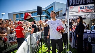 Charlie Kirk hands out hats before speaking at Utah Valley University in Orem, Utah, Wednesday, Sept. 10, 2025