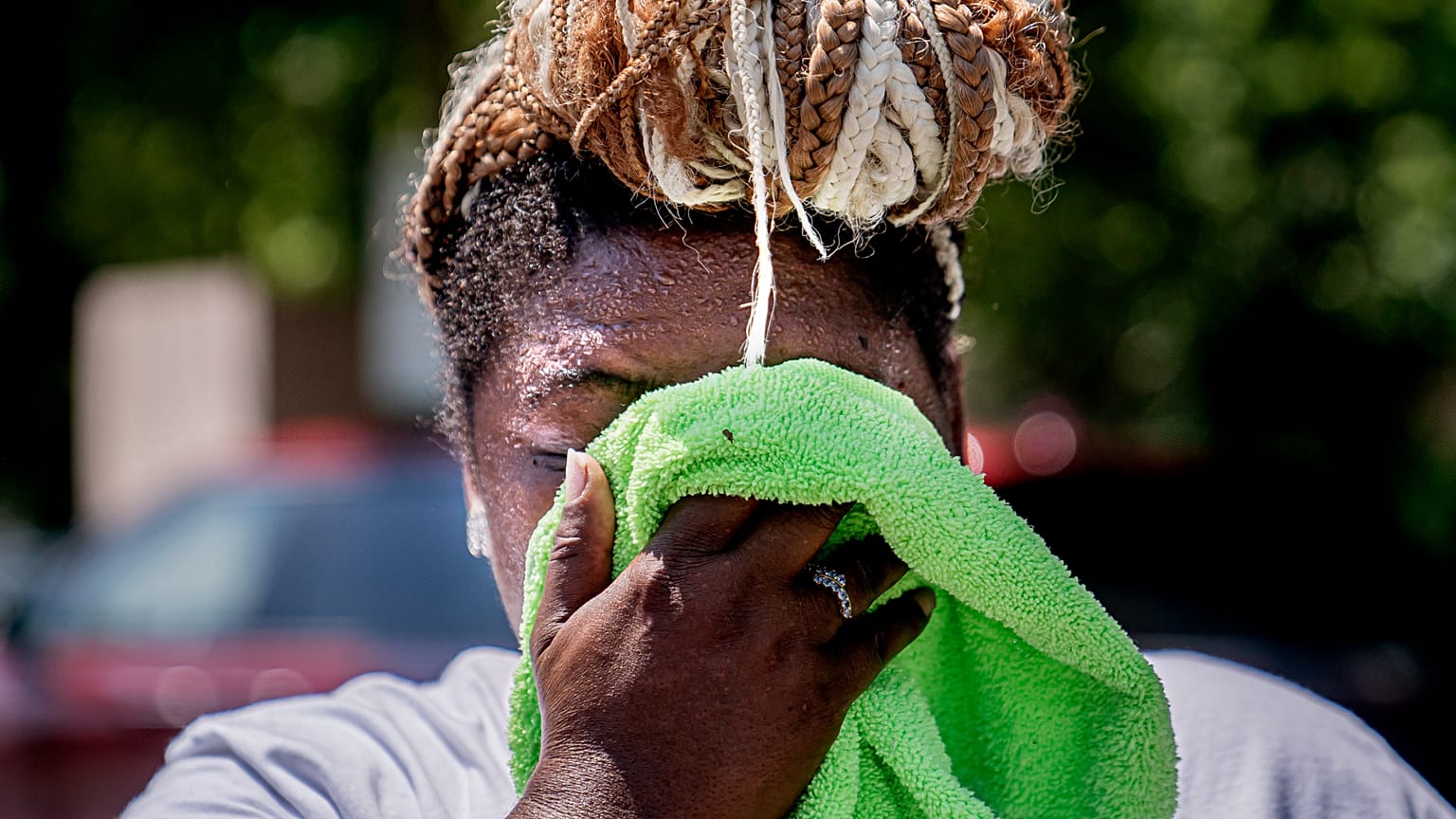 A woman wipes her face while setting up a drinks stand near the National Mall in Washington, US. 