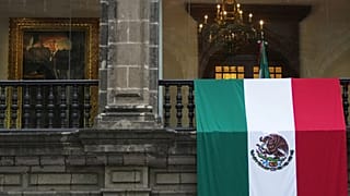 A Mexican flag hangs at the National Palace as President Claudia Sheinbaum delivers her first state-of-the-nation address in Mexico City. 1 Sept. 2025.