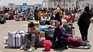Afghan refugees who returned after fleeing Iran to escape deportation and conflict gather at a UNHCR facility in western Herat province, Afghanistan