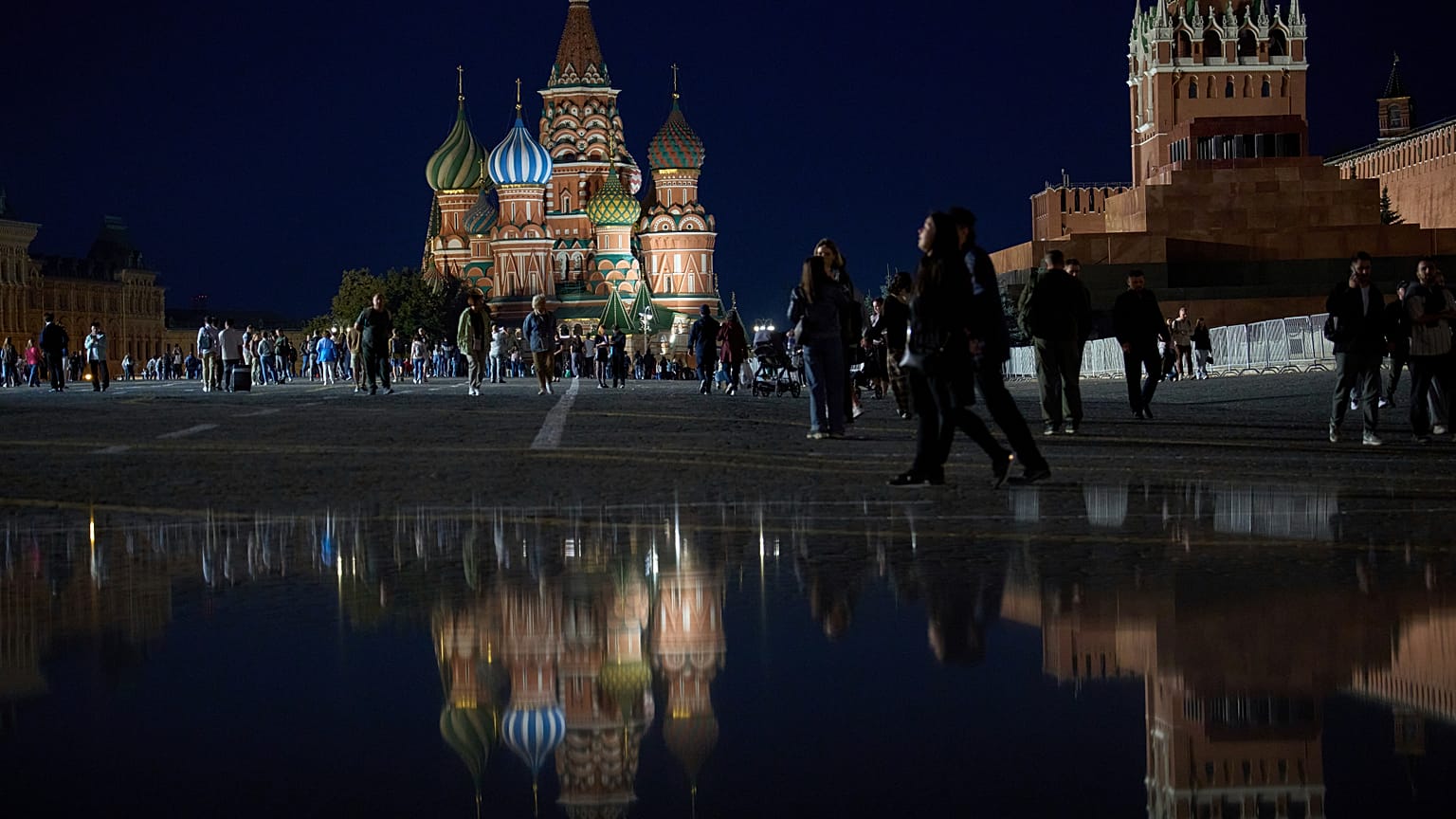 People enjoy a warm evening walking on Red Square in Moscow, Russia