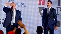 FILE: US President Donald Trump is joined on stage with Turning Point USA Founder Charlie Kirk as he finishes speaking at a summit in Washington, 23 July 2019