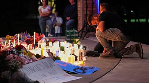 A man kneels during a vigil for Charlie Kirk, the CEO and co-founder of Turning Point USA who was shot and killed, Thursday, Sept. 11, 2025, in Orem, Utah. (AP Photo)