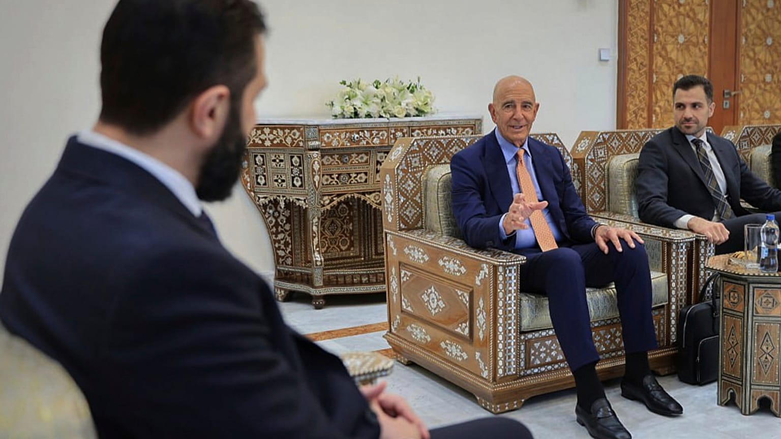  يلتقي السفير الأمريكي في تركيا والمبعوث الخاص إلى سوريا توم باراك (يمين، وسط)، مع الرئيس السوري المؤقت أحمد الشرع (يسار)، في دمشق، سوريا، يوم الاثنين 25 أغسطس/آب 2025. 