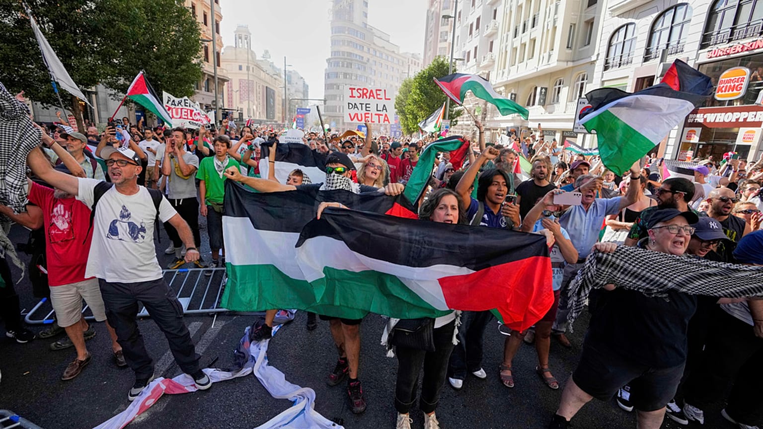 Protesters block the road in an attempt to disrupt the twenty-first stage of the Spanish cycling race La Vuelta, from Alalpardo to Madrid, Spain, Sunday, Sept. 14, 2025. 