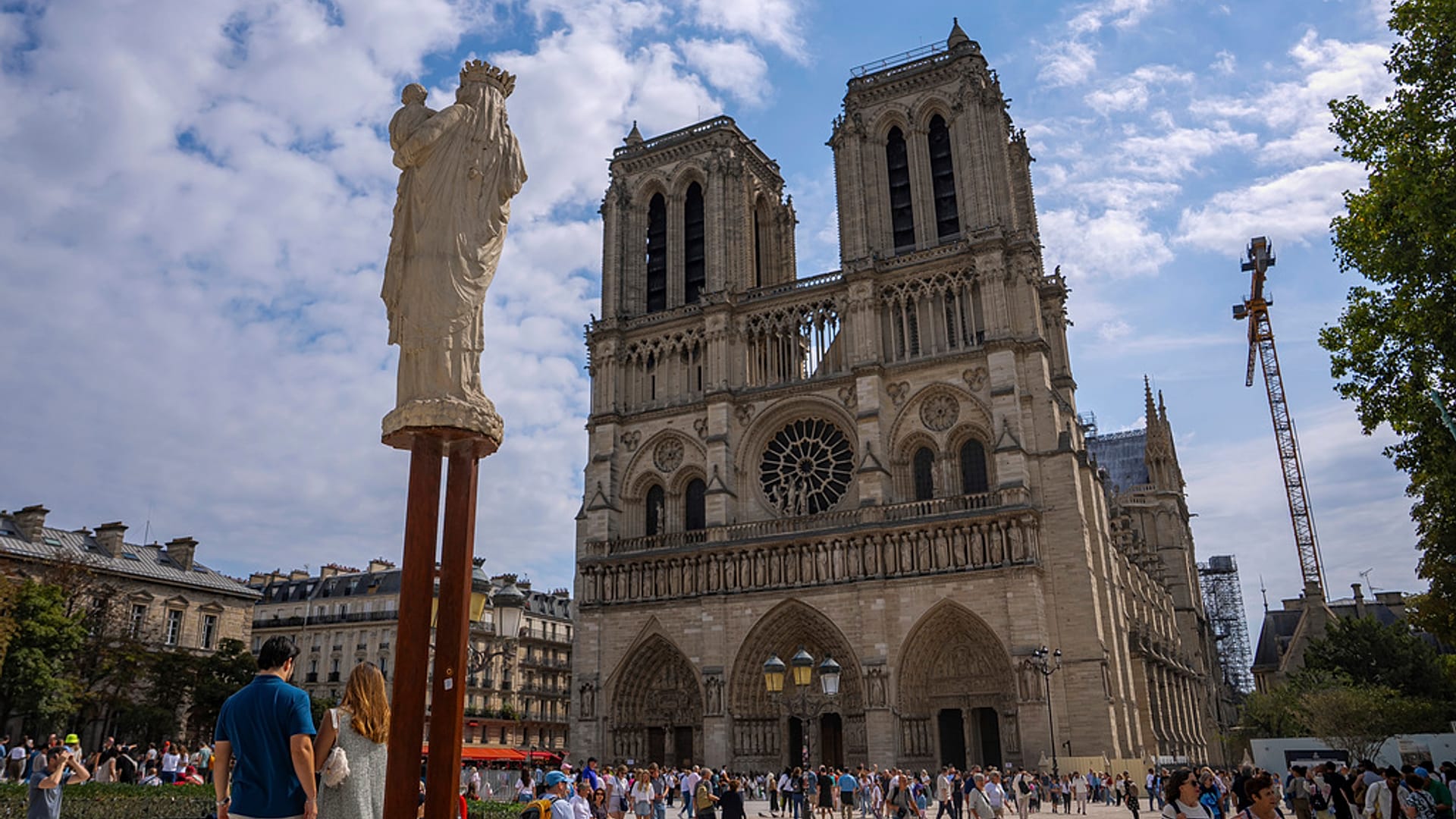 People walk on the forecourt of Notre Dame Cathedral in Paris, 21 August 2025.