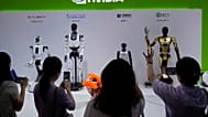 FILE - Visitors give commands to a robot at Nvidia's booth during the 3rd China International Supply Chain Expo in Beijing, 18 July 2025.