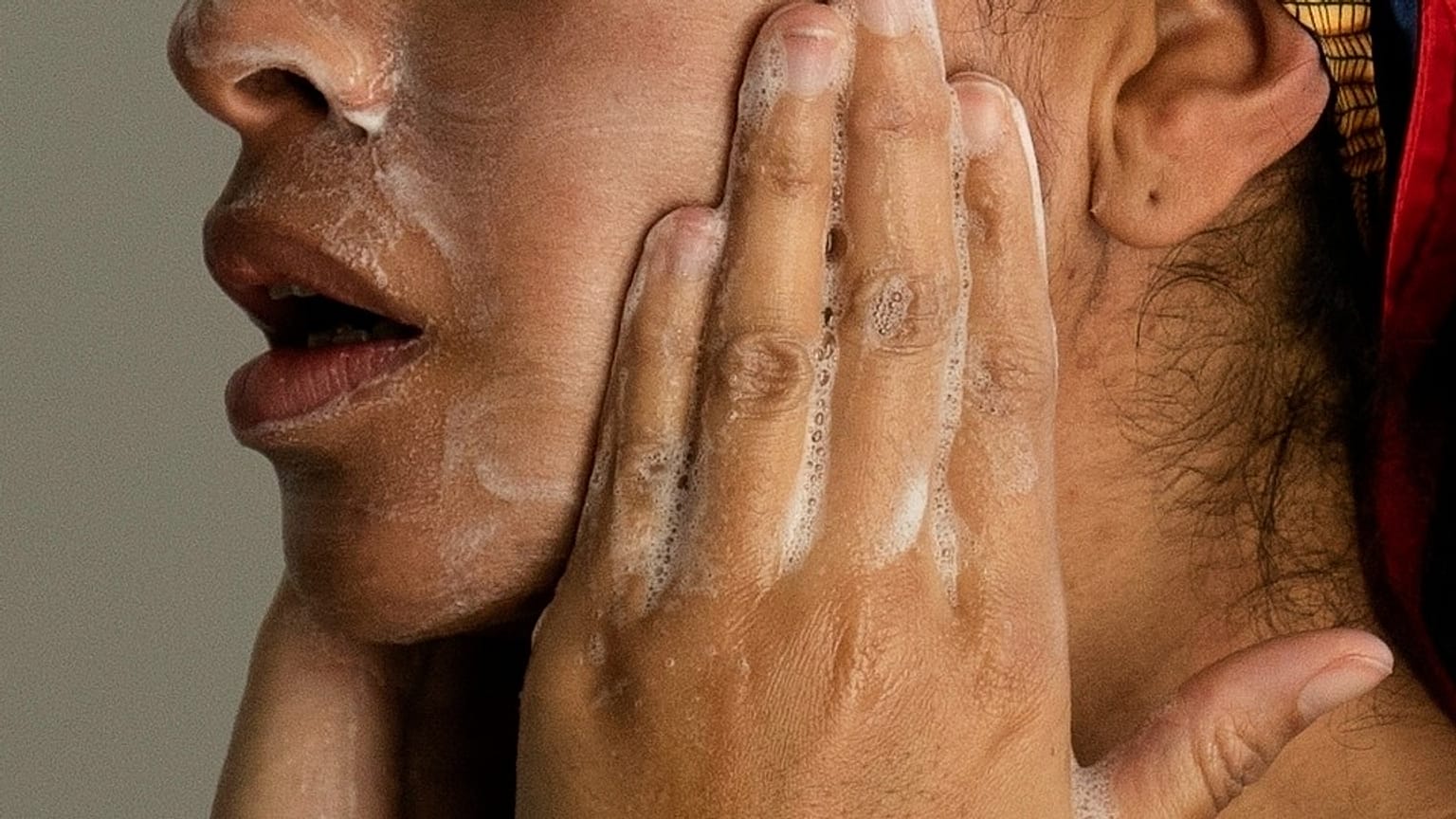 A woman washes her face this file photo from Feb. 10, 2023.