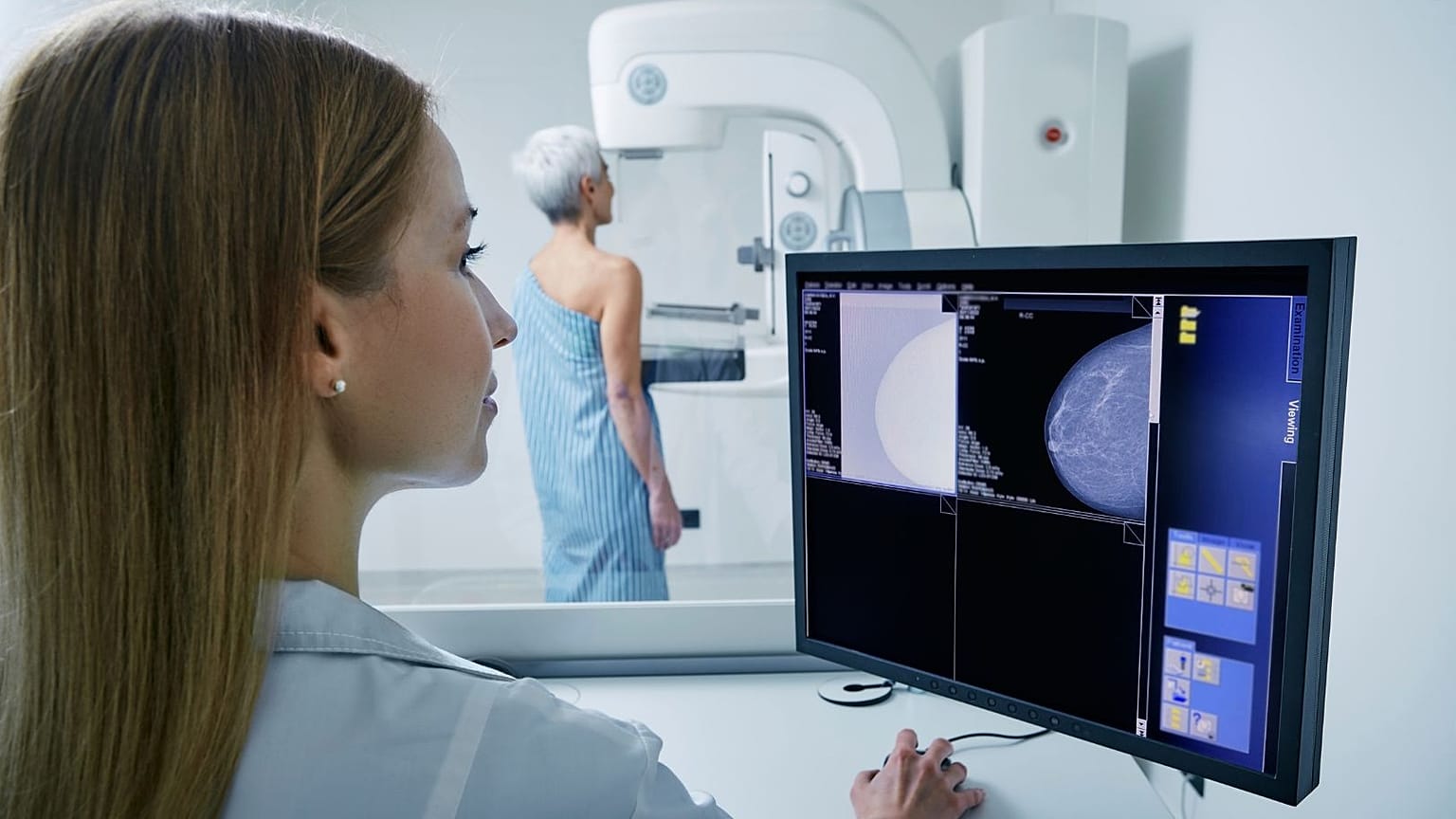 A woman undergoes a mammogram.