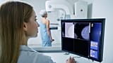 A woman undergoes a mammogram.