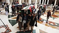 People carry the coffins of 31 local journalists reportedly killed in Israeli airstrikes last week, out of the Shaab Mosque during their funeral in Sanaa, 16 September 2025