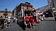 Paramedics provide aid to tourists and residents with an ambulance, next to the historical Spanish Steps, in Rome, Italy, July 1, 2025.