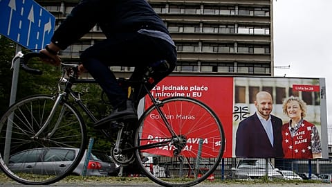 A cyclist rides past a billboard for EU elections, in Zagreb, Croatia.