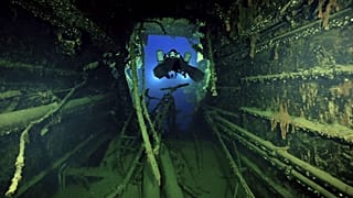 Divers illuminate the wreck's interior of the Britannic, sister ship to the Titanic, for the first time since the ocean liner sank in the Aegean Sea