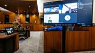 Defense attorney Greg Skordas, left, speaks before judge Tony Graf, back center left, as Tyler Robinson, accused of shooting Charlie Kirk, attends a virtual court hearing.