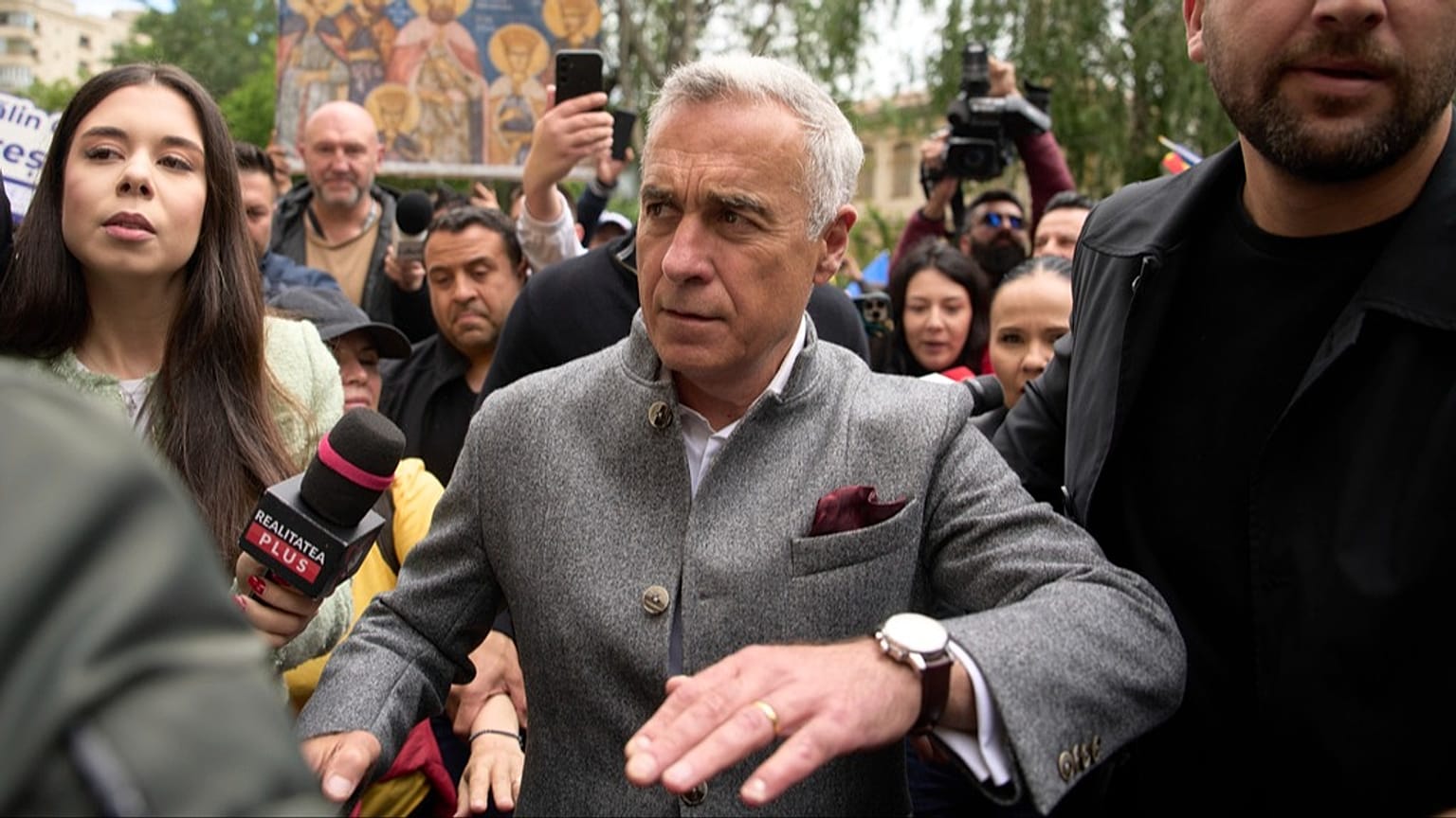 FILE: Calin Georgescu, the winner of the first round of last year's annulled election, arrives at a prosecutor's office in Bucharest, Romania, Tuesday, May 27, 2025