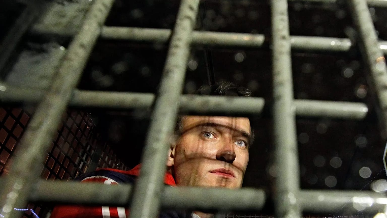 Opposition leader Alexei Navalny is seen behind bars in a police van after being detained during protests in Moscow, 8 May, 2012