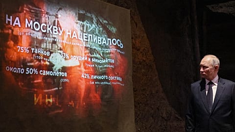 Putyin orosz elnök egy világháborús poszter előtt, 2023 június