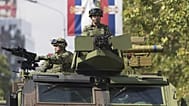 Serbian Army armored vehicles drive ahead of a military parade scheduled for 20 September in Belgrade, 12 September 2025