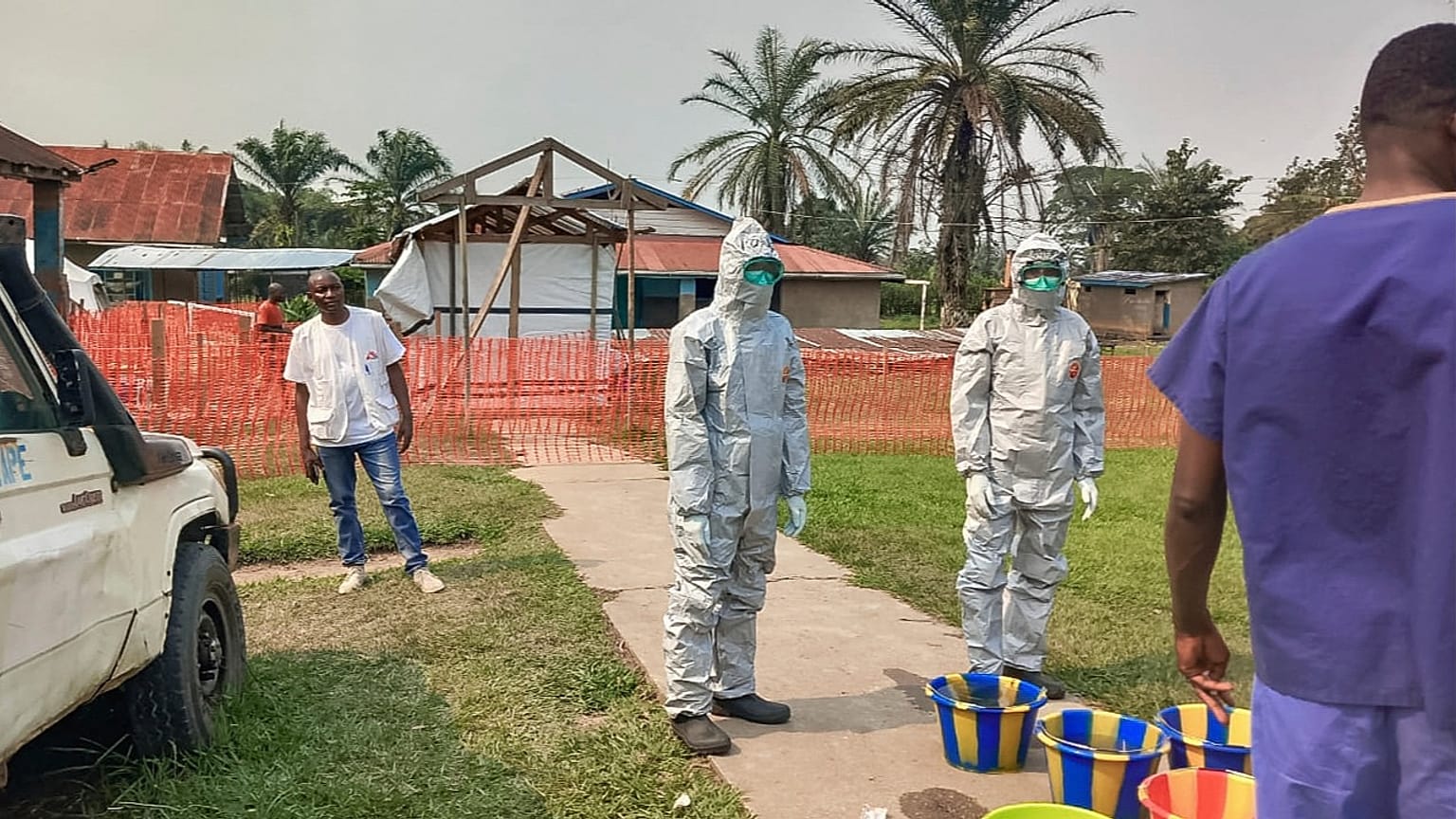 In this photo provided by Doctors Without Borders, men stand outside an Ebola treatment centre in the Bulape Health Zone in the Democratic Republic of Congo on Sept 7, 2025.