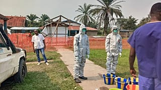 In this photo provided by Doctors Without Borders, men stand outside an Ebola treatment centre in the Bulape Health Zone in the Democratic Republic of Congo on Sept 7, 2025.