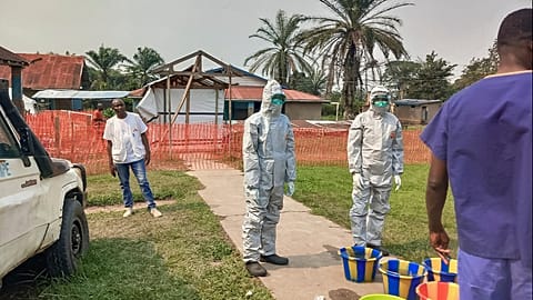 In this photo provided by Doctors Without Borders, men stand outside an Ebola treatment centre in the Bulape Health Zone in the Democratic Republic of Congo on Sept 7, 2025.