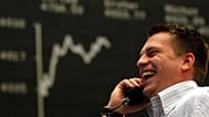A stock trader on the phone in front of the German Stock Index (DAX) display board at the stock exchange in Frankfurt, western Germany. 2005.