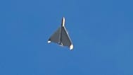 FILE: An Iranian Shahed exploding drone launched by Russia flies through the sky seconds before it strikes buildings in Kyiv, 17 October 2024