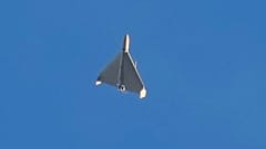 FILE: An Iranian Shahed exploding drone launched by Russia flies through the sky seconds before it strikes buildings in Kyiv, 17 October 2024