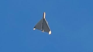 FILE: An Iranian Shahed exploding drone launched by Russia flies through the sky seconds before it strikes buildings in Kyiv, 17 October 2024