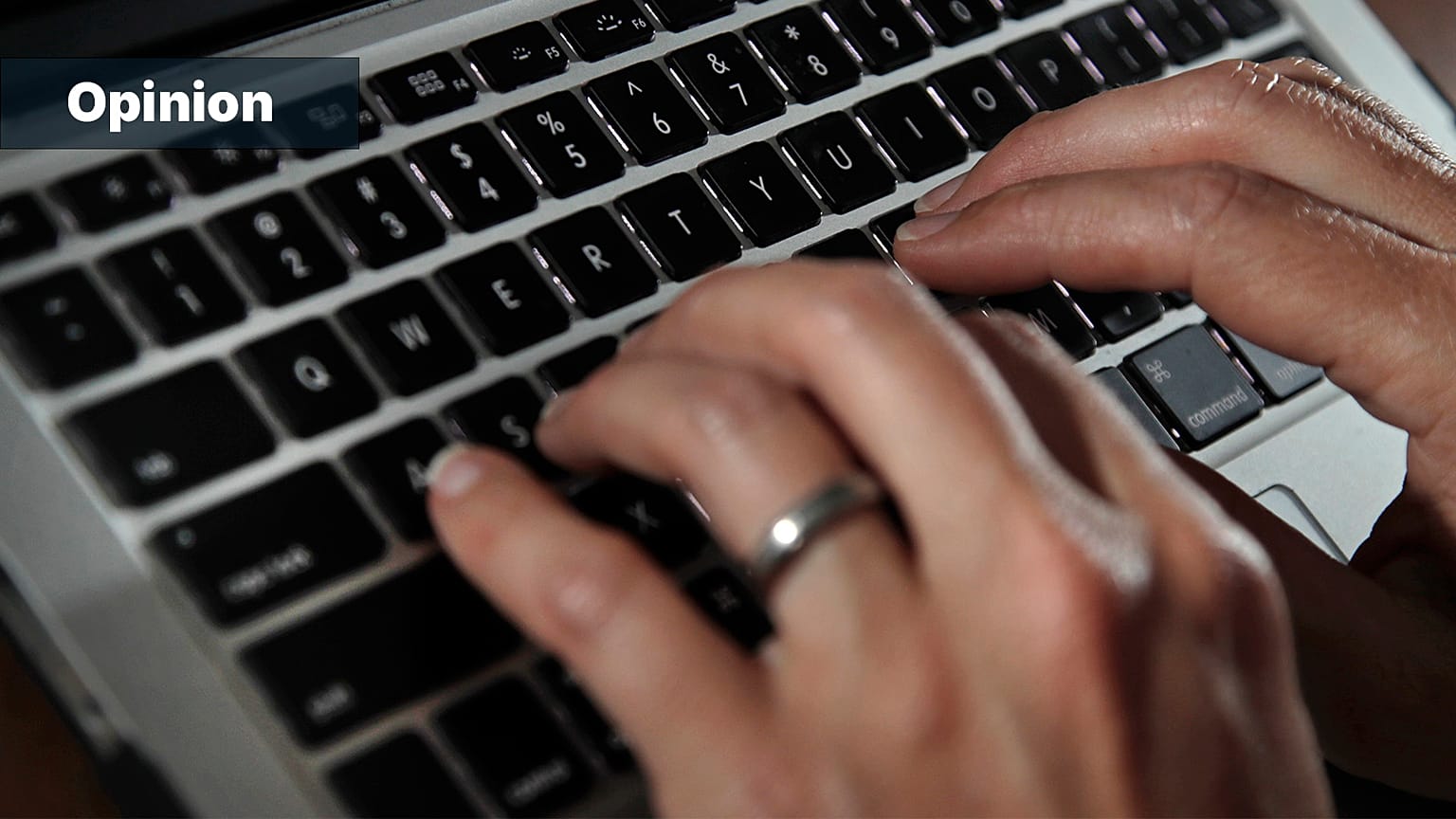 FILE: A person types on a laptop keyboard in North Andover, MA, 19 June 2017