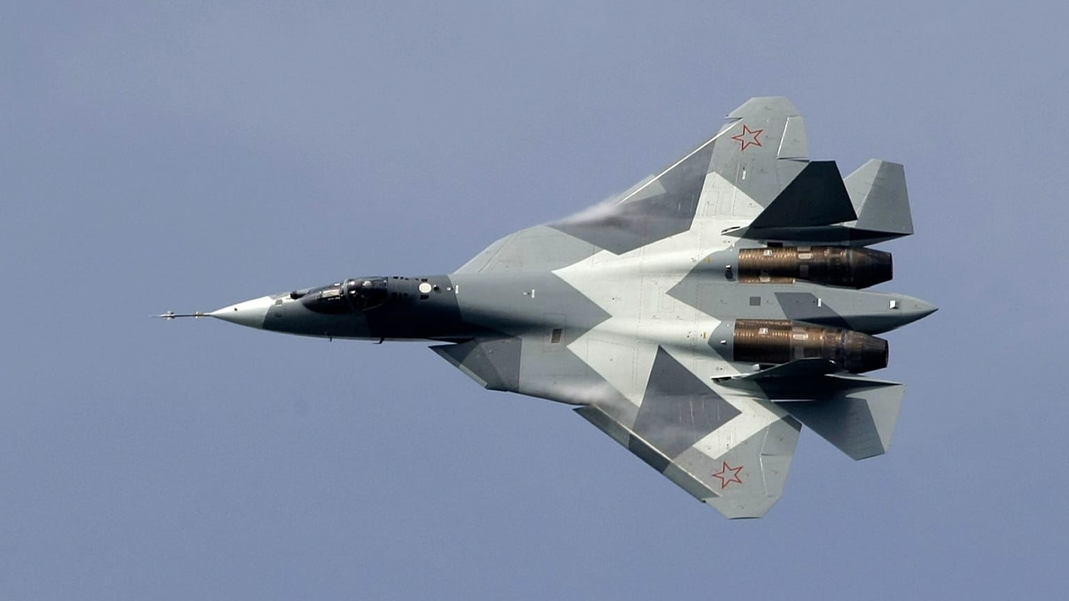 FILE - A new Russian twin-engine jet fighter T-50 flies over Zhukovsky airfield as it takes part in MAKS-2011,