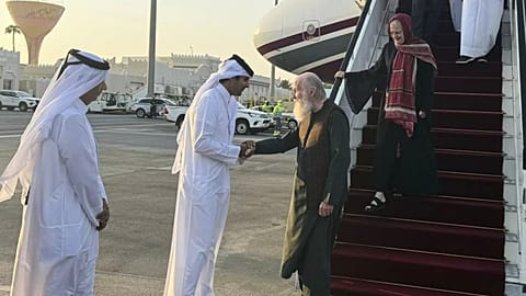 A Qatari official welcomes the released British couple, Barbie and Peter Reynolds, as they step off the plane upon their arrival in Doha, Qatar, Friday, Sept. 19, 2025.