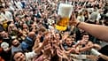 Eyes on the prize: Oktoberfest goers reach out for the first glasses of beer in Munich 
