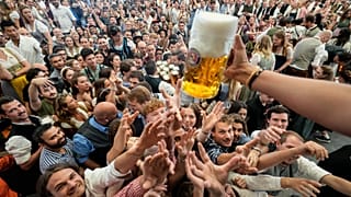 Eyes on the prize: Oktoberfest goers reach out for the first glasses of beer in Munich 