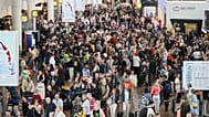 People walk by a departures board after a cyber attack caused delays at Brussels International Airport in Zaventem, Belgium, Saturday, Sept. 20, 2025.