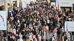 People walk by a departures board after a cyber attack caused delays at Brussels International Airport in Zaventem, Belgium, Saturday, Sept. 20, 2025.