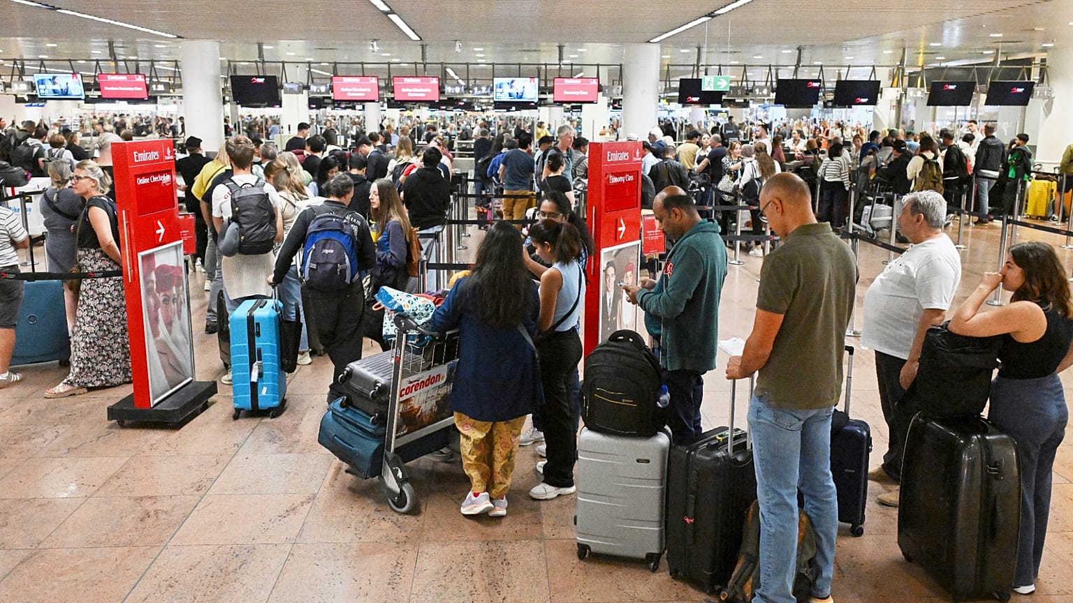 People stand in a line to check in after a cyber attack caused delays at Brussels International Airport in Zaventem, Belgium, Saturday, Sept. 20, 2025. 