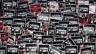 People hold up signs during a memorial for conservative activist Charlie Kirk, 21 September 2025
