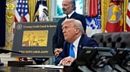 President Donald Trump, seated, and Commerce Secretary Howard Lutnick listen to questions from reporters in the Oval Office of the White House, Friday, Sept. 19, 2025. 