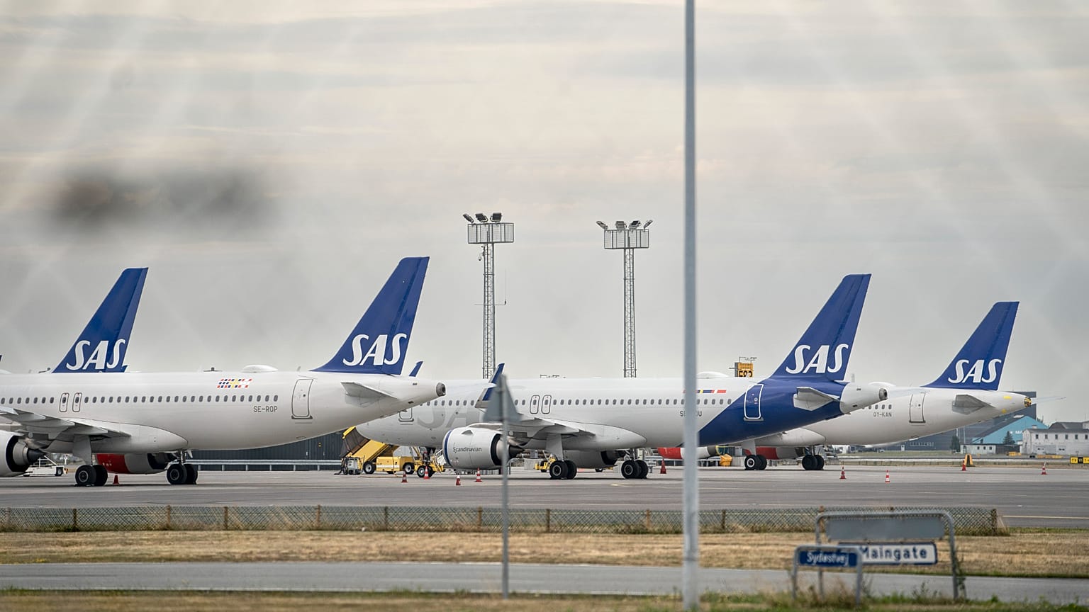 SAS aircrafts are seen through a fence, parked on the ground during the pilot strike, at Copenhagen Airport, Monday, July 18, 2022.
