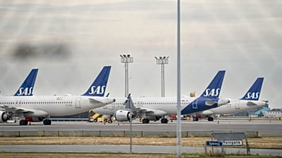 SAS aircrafts are seen through a fence, parked on the ground during the pilot strike, at Copenhagen Airport, Monday, July 18, 2022.