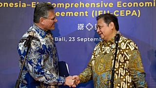 Indonesian Coordinating Minister for Economic Affairs Airlangga Hartarto, right, shakes hands with EU Commissioner for Trade Maros Sefcovic, in Bali on September 23, 2025. 