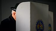 FILE: A man prepares to cast his vote during a presidential election runoff, in Chisinau, Moldova, Sunday, Nov. 3, 2024
