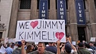 Oscar Villanueva holds a sign outside El Capitan Entertainment Centre, where the late-night show "Jimmy Kimmel Live!" is staged. 18 Sept. 2025.